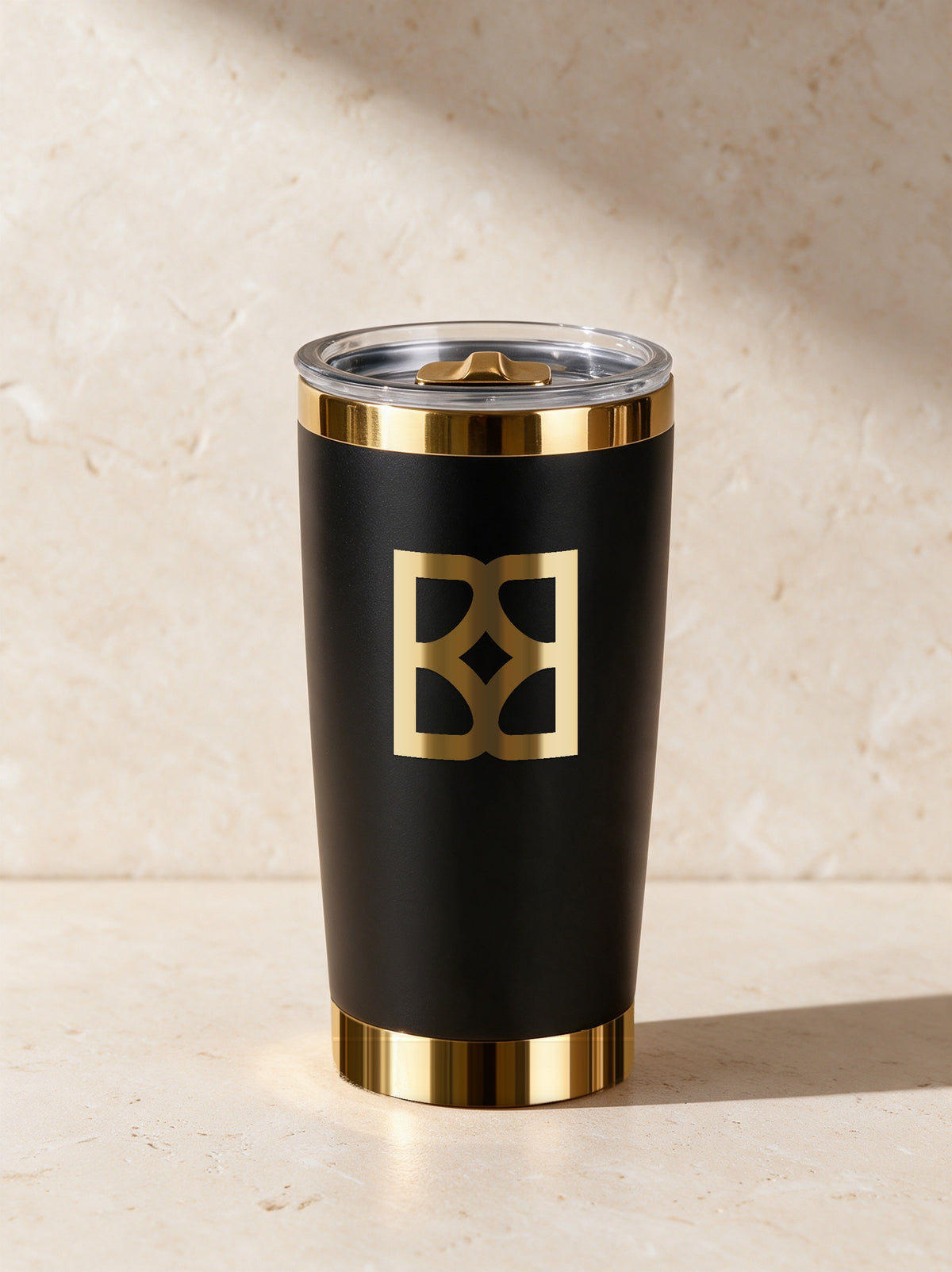 Example proof: the Branded Best mark engraved top-center in polished gold on the tumbler