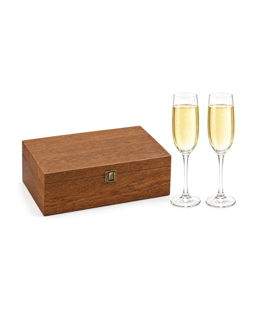 Two champagne flutes beside their walnut-tone wooden gift box