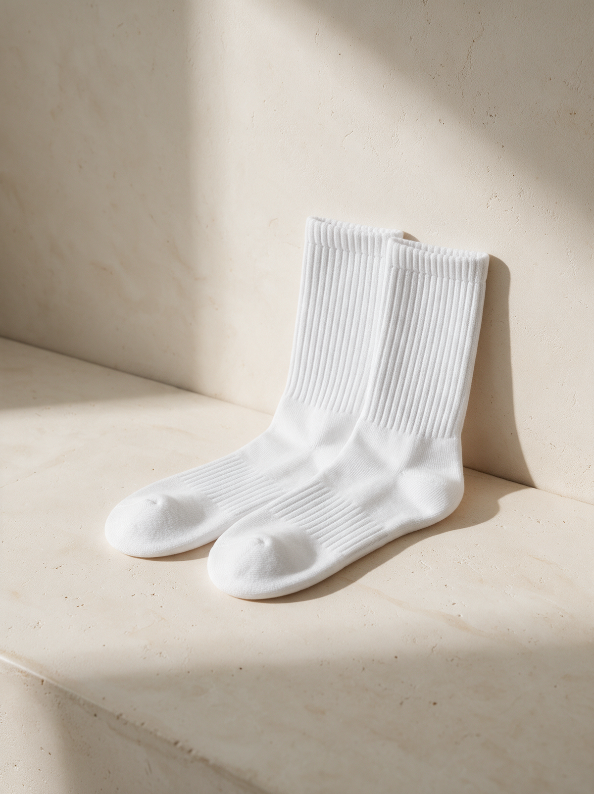 Cotton socks, White, a pair on warm stone