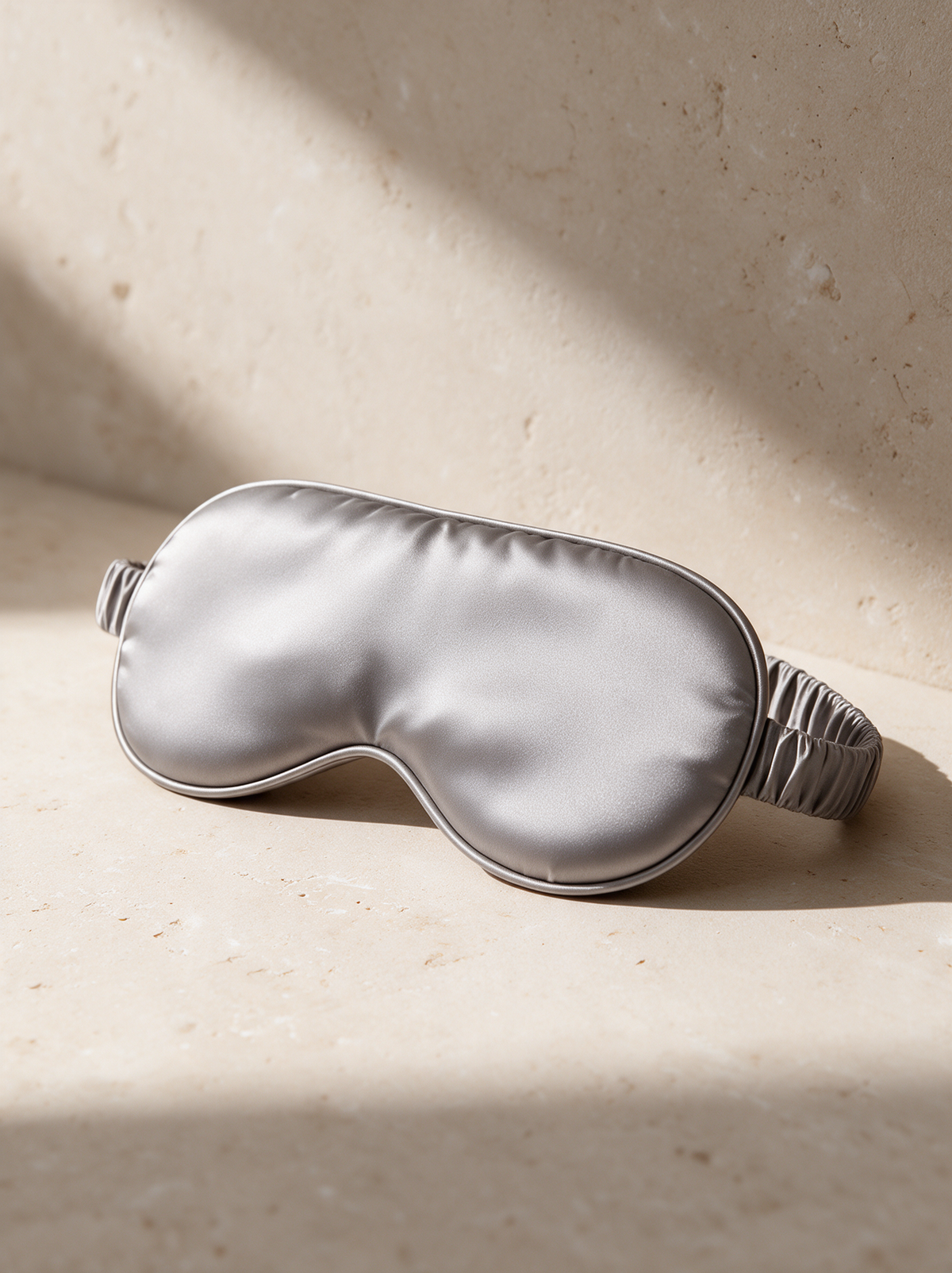 The Silk Sleep Mask in a warm stone setting